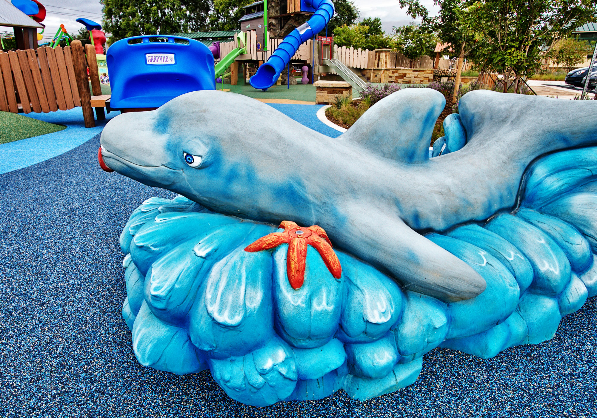 Dolphin sculpture at sea themed playground